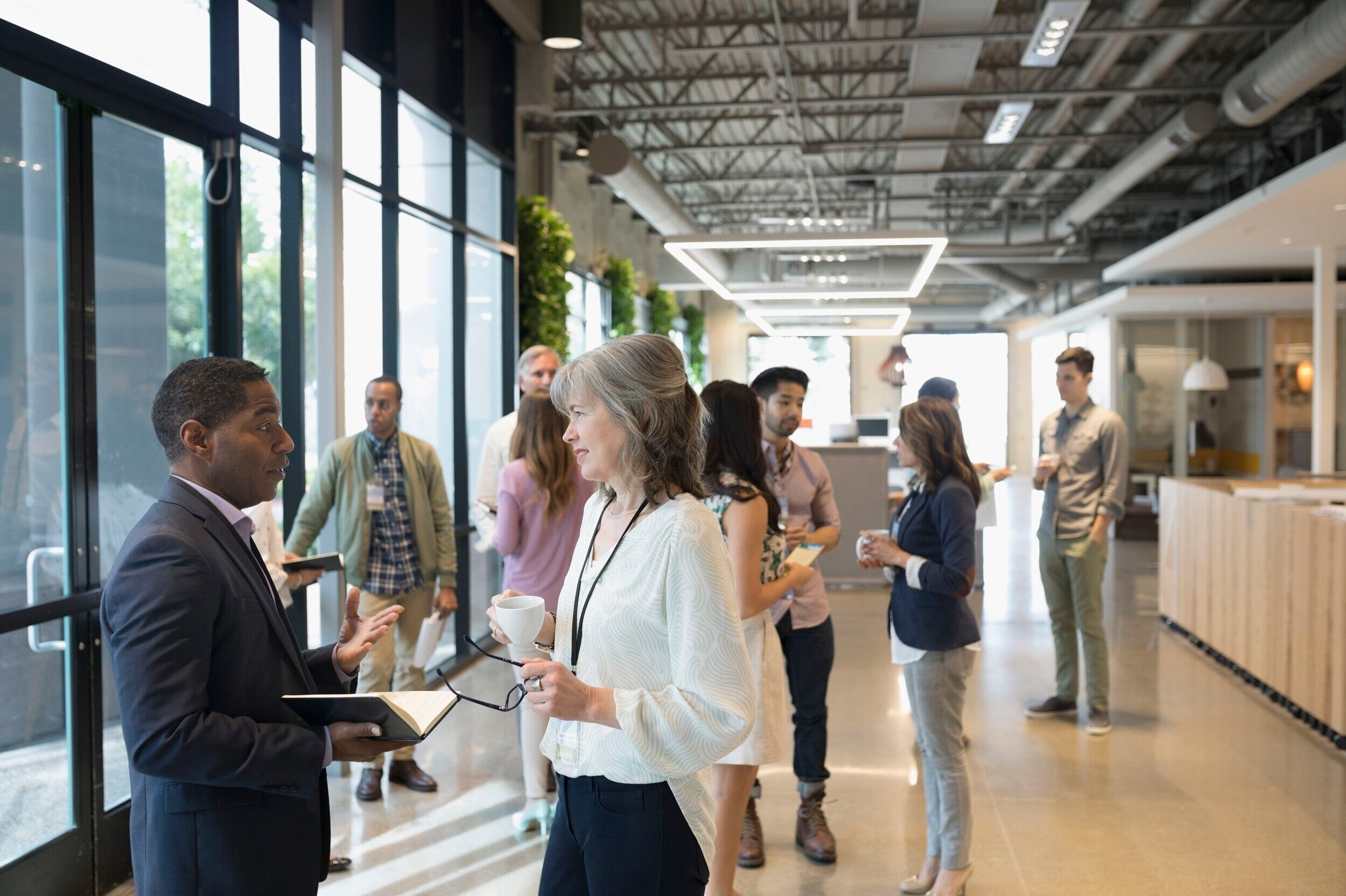 business-people-networking-in-office-lobby-719876715-5aced74504d1cf00376cebb8.jpg